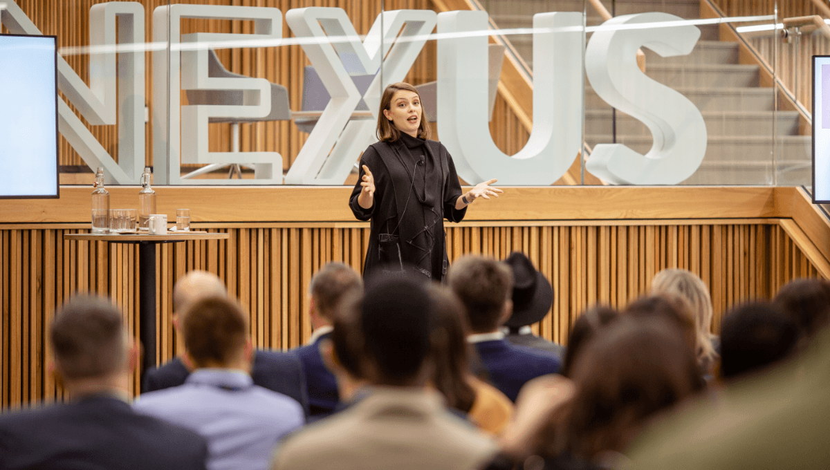 Female presenter in the Atrium of Nexus