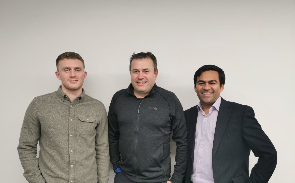 Group shot of 3 members of the Itecho Health team, stood and smiling to camera- taken before lockdown