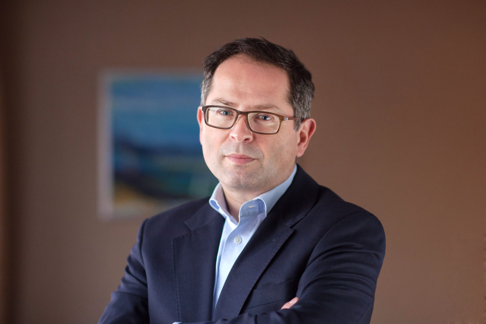 Jonathan Jones stands with arms crossed looking directly at camera