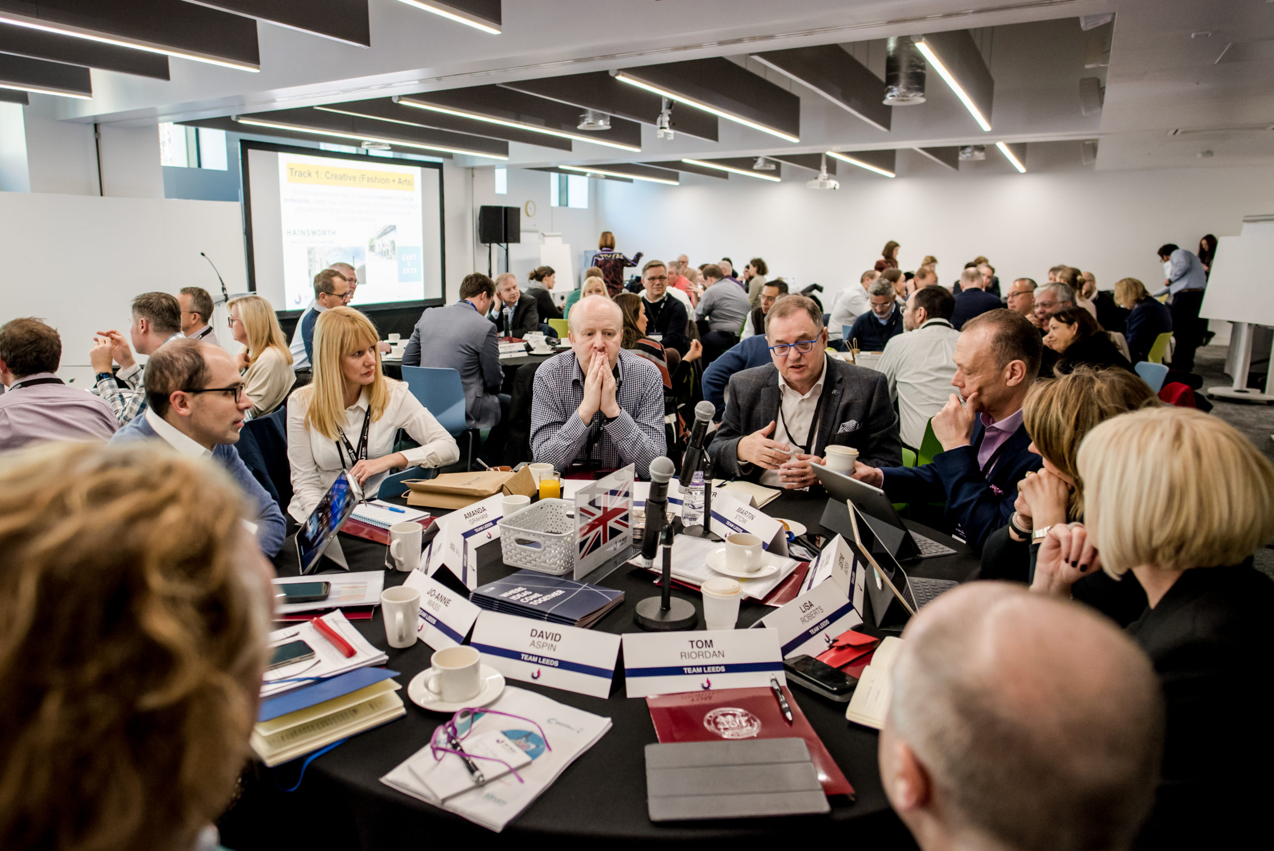 Team Leeds from the MIT REAP programme sat around a round table talking during a workshop