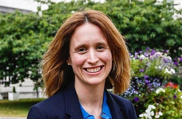 Head and shoulders shot of Eve Roodhouse, Chief Officer, Culture and Economy at Leeds City Council. She is stood outside in front of some trees and is smiling to camera