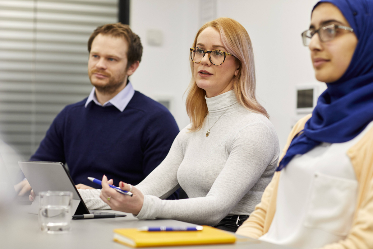 Three people listening intently