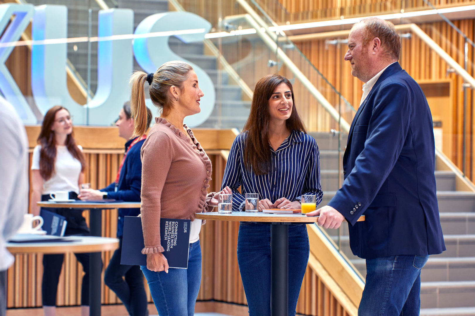 Three people talking at an event