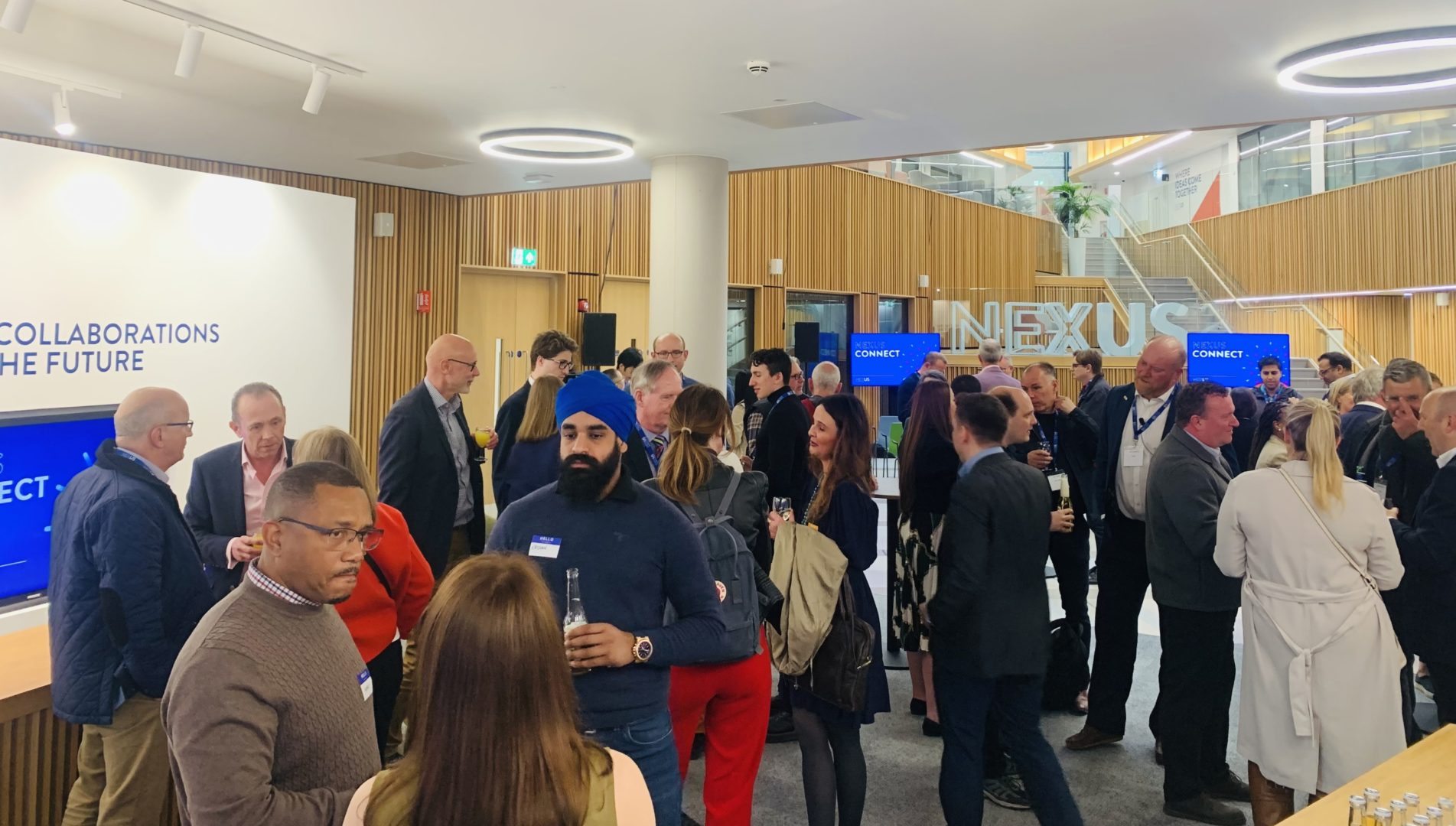 People networking in the Nexus Atrium at Nexus Connect