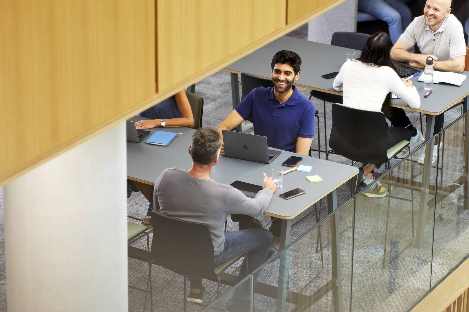 Two men working at a table in the Nexus atrium