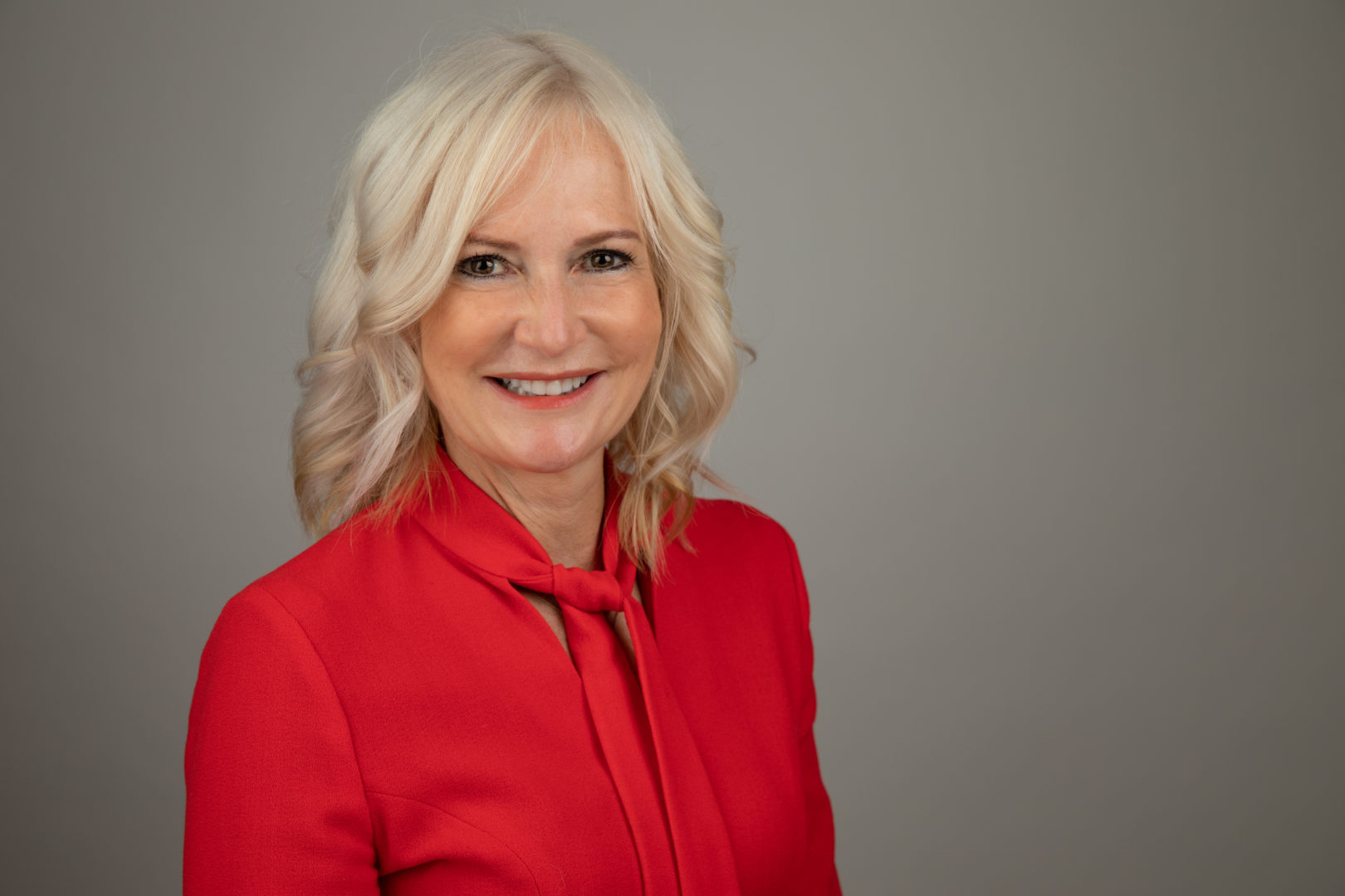 Head and shoulders image of Helen Oldham, smiling to camera