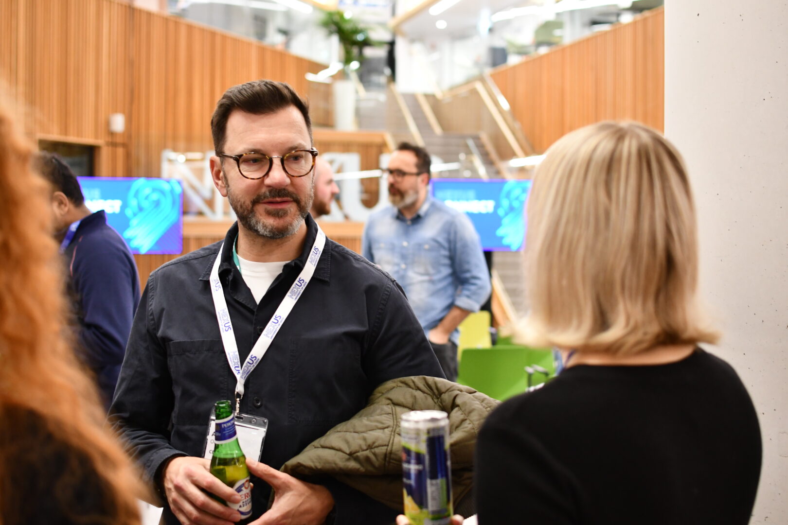 People networking while holding drinks