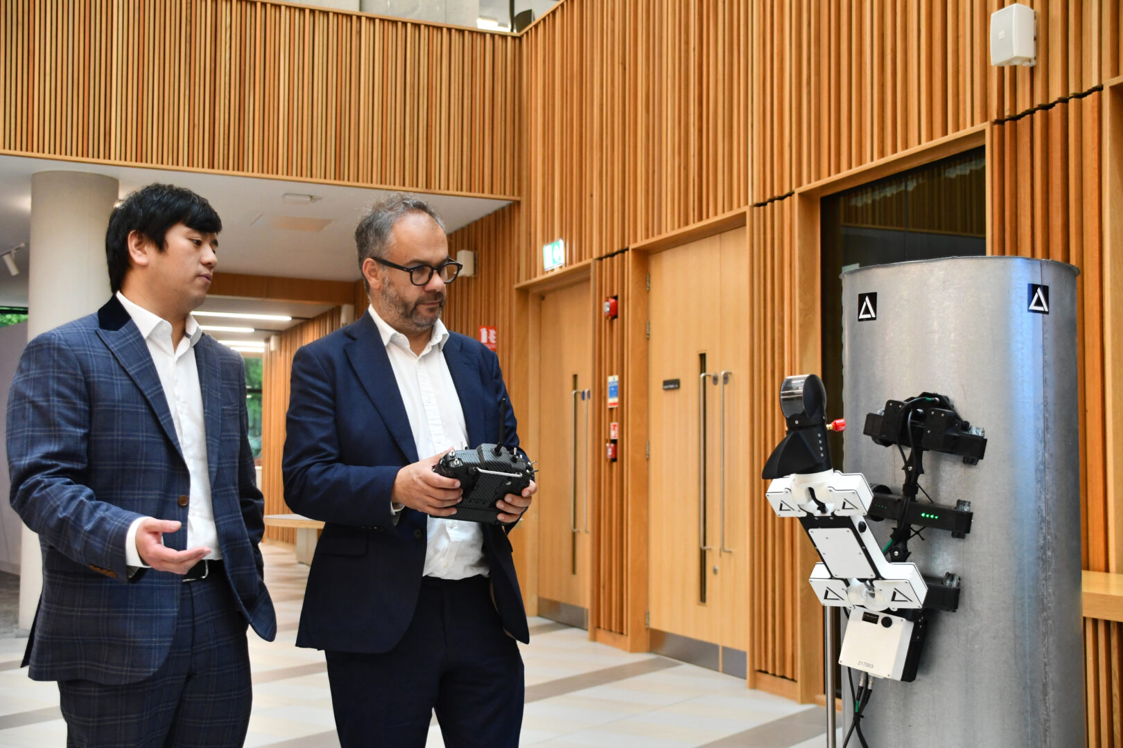 Paul Scully MP operates a robot in the Nexus building.